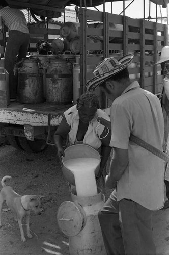 Woman pours milk into a pot, San Basilio de Palenque, 1975