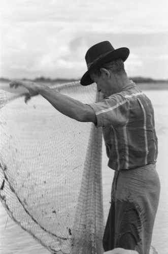 Fisherman holding a net, La Chamba, Colombia, 1975