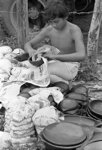 Wrapping clay pieces, La Chamba, Colombia, 1975