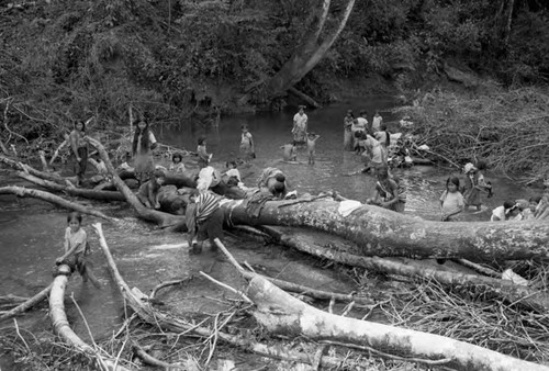 Refugee women and girls wash their clothes at a river, Chiapas, 1983