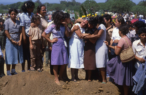 A woman is consoled by other grieving women, Nicaragua, 1983