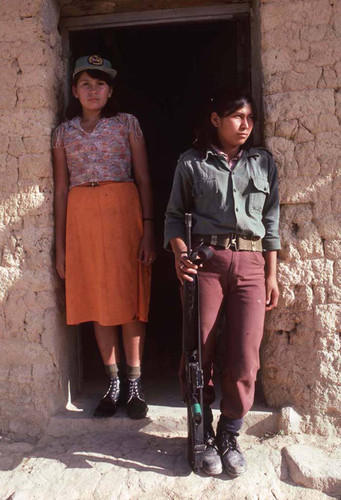 Woman guerrilla and civilian in occupied town, La Palma, 1983