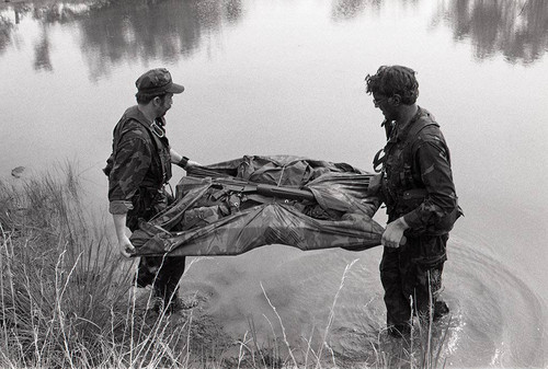 Survival school students carry supplies in a raft, Liberal, 1982