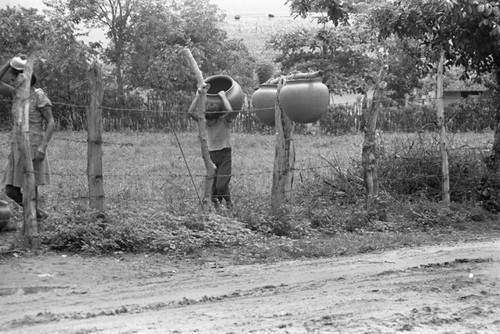 Transporting clay goods, La Chamba, Colombia, 1975