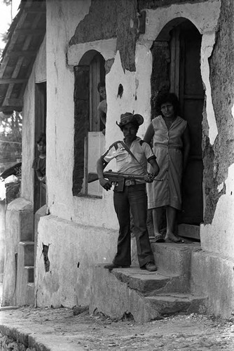 Paramilitary man guarding a home, Alegría, Usulután, 1983