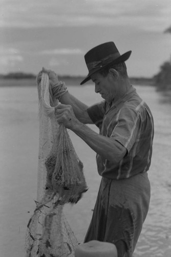 Fisherman holding a net, La Chamba, Colombia, 1975