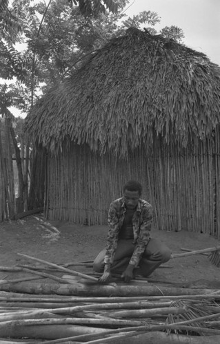 Man smoothing wood, San Basilio de Palenque, 1977