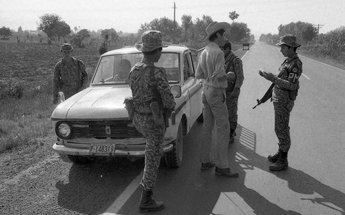 Soldiers surround pick up truck at a checkpoint, Guatemala, 1982