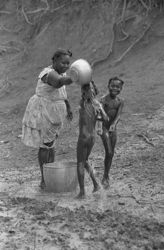 Woman bathing children, San Basilio de Palenque, Colombia, 1977