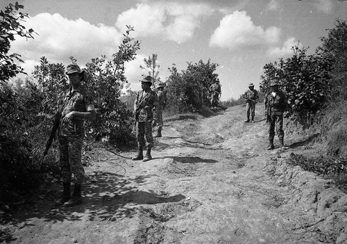 Armed soldiers stopped on a dirt road, Guatemala, 1982