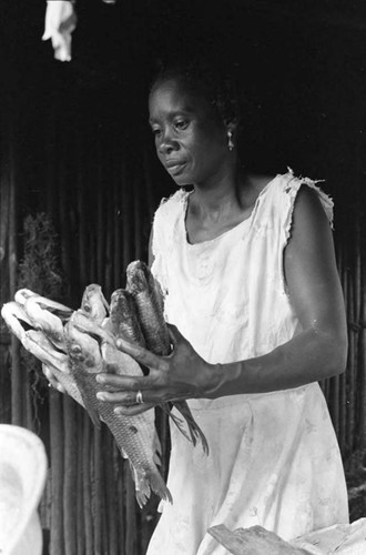 Woman holding fish in her hands, San Basilio de Palenque, 1975