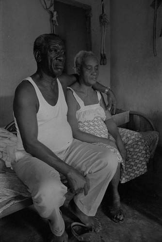 Fermín and Florentina Herrera sitting on bed, San Basilio de Palenque, 1977