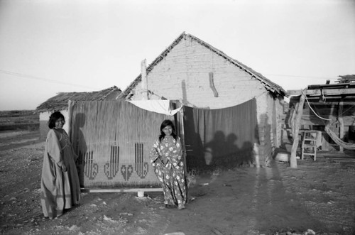 Wayuu women near large weaving, La Guajira, Colombia, 1976