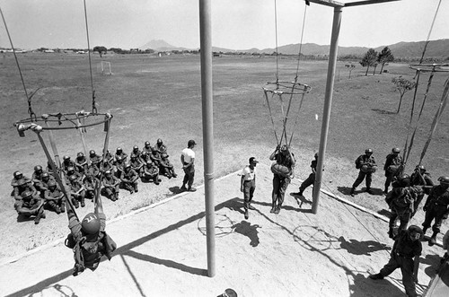 Salvadoran soldiers receiving parachute training at military base, Ilopengo, 1983