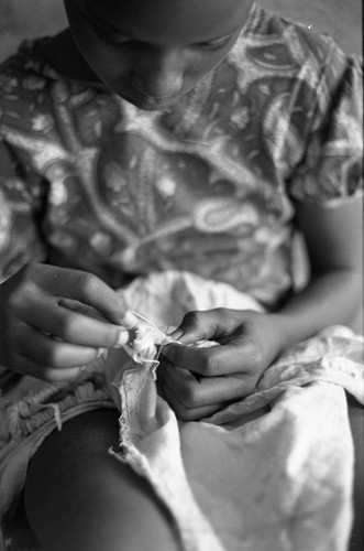 Girl sewing a garment, San Basilio de Palenque, 1977