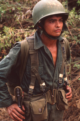 Soldier standing holding a rifle, San Antonio de los Ranchos, Chalatenango, El Salvador, 1981