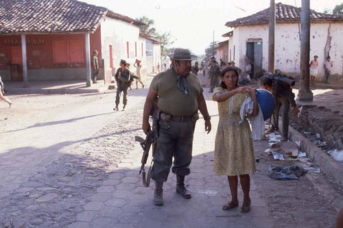 A Salvadoran military commander talking to a civilian in the streets, San Agustín, 1983