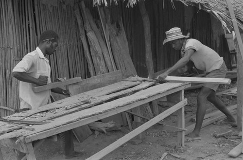 Two men working at a construction table, San Basilio de Palenque, 1977