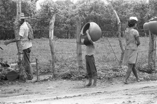 Transporting clay goods, La Chamba, Colombia, 1975