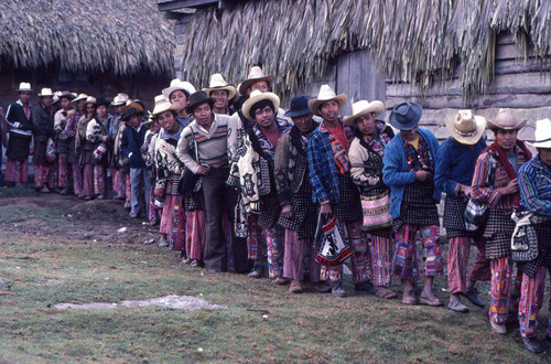 Mayan men wait in line to vote, Guatemala, 1982