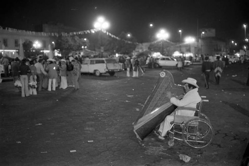 Man using wheelchair plays the harp, Mexico City, 1982