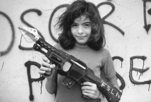 Girl with toy rifle, Nicaragua, 1979