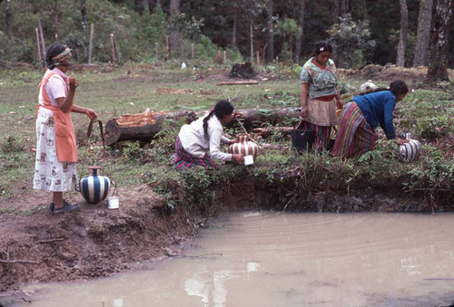 Guatemalan refugees collecting water at a River, Santiago el Vértice, 1983