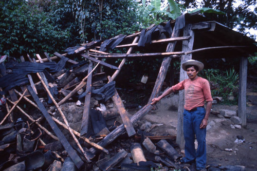 Man looks at destroyed shack, Honduras, 1983