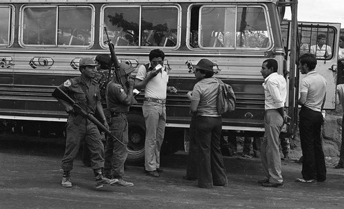 Army soldiers check bus passengers' identification cards, Cabañas, 1982