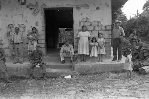 Civilians and army soldiers in front of building, Perquín, 1983