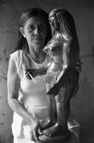 Woman and a statue, La Chamba, Colombia, 1975