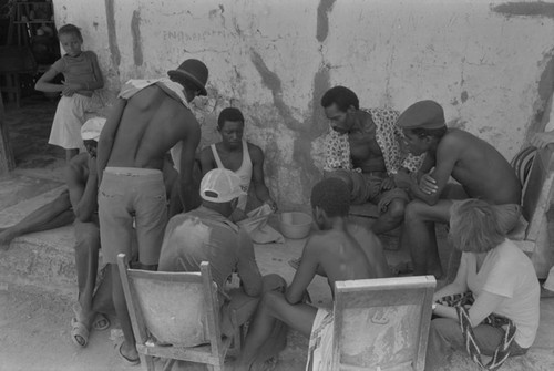 Nina S. de Friedemann watches men playing a game, San Basilio de Palenque, ca. 1978