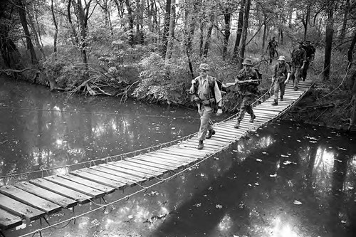 Survival school students cross a bridge, Liberal, 1982