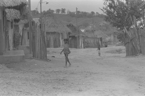 Girl walking with container on her head, San Basilio de Palenque, 1976