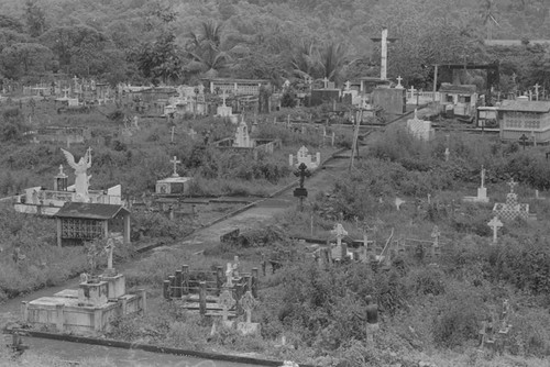 Distant view of a man landscaping a cemetery, Barbacoas, Colombia, 1979