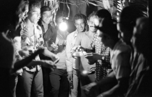 Men celebrating in the evening, Barranquilla, Colombia, 1977