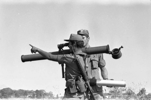 A U.S. military advisor training a Salvadoran soldier at Ilopango Military Base, Ilopango, 1983