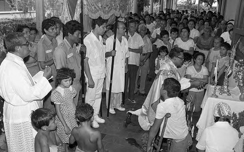 Priest prays in front of a group, Nicaragua, 1979