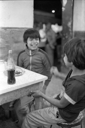 Two boys at a restrauant, Mexico City, 1982