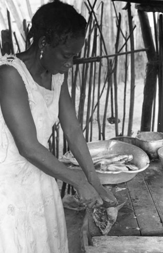 Woman cleaning fish, San Basilio de Palenque, 1975