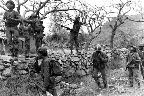 Soldiers picking fruit on patrol, Chalatenango, 1981