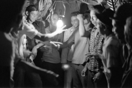 Men celebrating in the evening, Barranquilla, Colombia, 1977