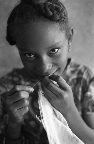 Girl sewing a garment, San Basilio de Palenque, 1977