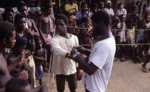 Boxer putting on boxing gloves, San Basilio de Palenque, 1976