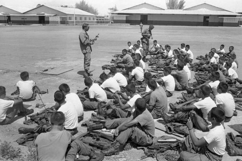 A U.S. military advisor trains Salvadoran soldiers at Ilopango Military Base, Ilopango, 1983