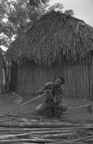 Man smoothing wood, San Basilio de Palenque, 1977