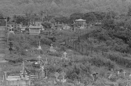 Distant view of a man landscaping a cemetery, Barbacoas, Colombia, 1979