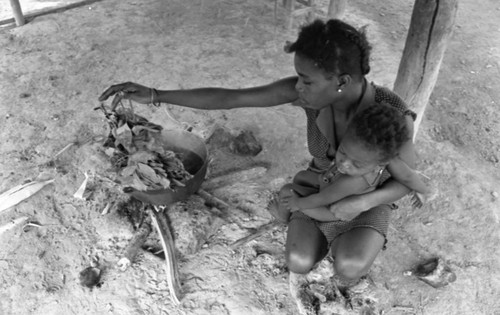 Young woman and infant by the fire, San Basilio de Palenque, 1977