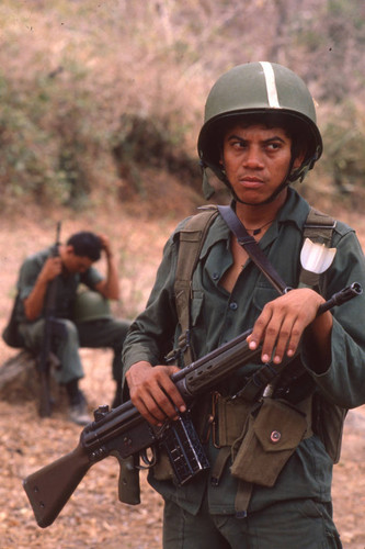 Soldier standing holding a rifle, San Antonio de los Ranchos, Chalatenango, El Salvador, 1981