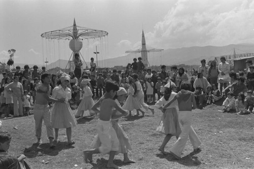 Children dancing at Tunjuelito's Christmas festivities, Tunjuelito, Colombia, 1977